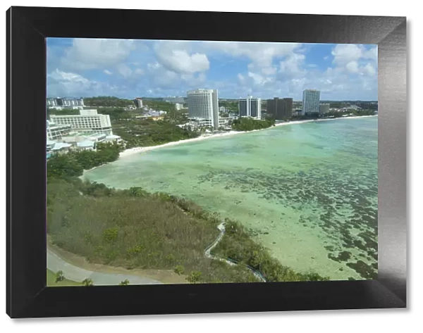 Guam USA Territory Tumon Bay hotels and beach from above with ocean beach and clouds
