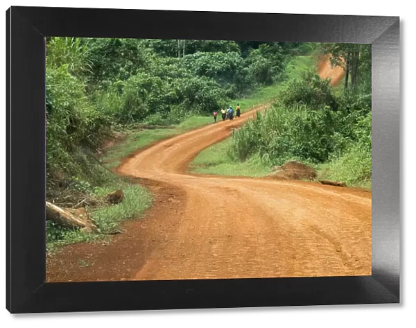 Local people traveling on dirt road, west Uganda