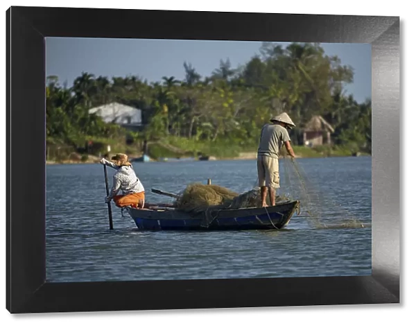 Fishing from boat on Thu Bon River, Hoi An (UNESCO World Heritage Site), Vietnam