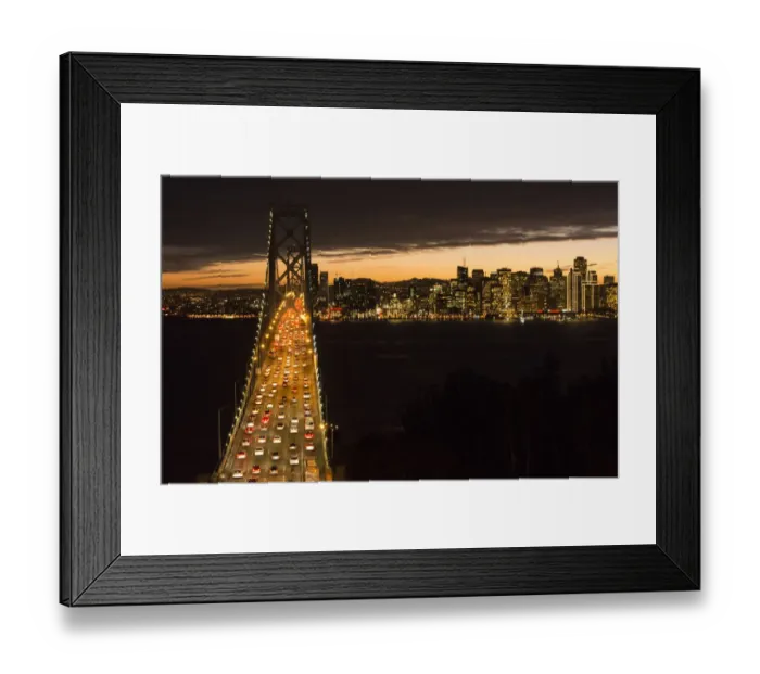 Framed Print : San Francisco California skyline and the Oakland Bay Bridge at evening with traffic on bridge