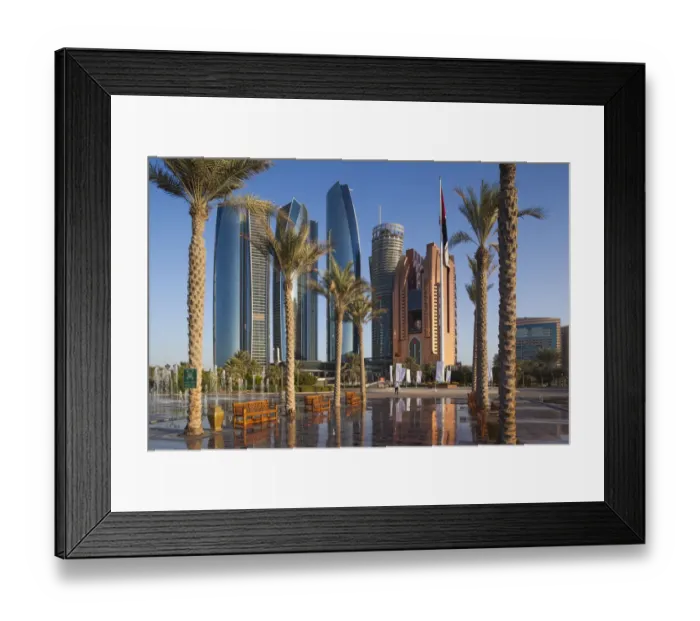 Framed Print : UAE, Abu Dhabi, Etihad Towers and Emirates Palace Hotel fountains, dusk