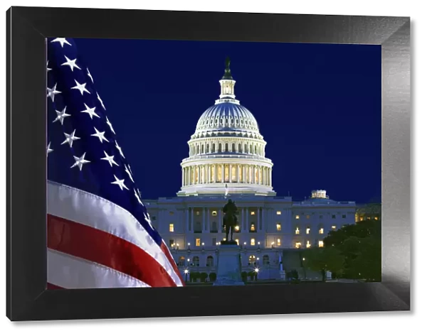 USA, Washington, DC. Capitol Building and US flag at night