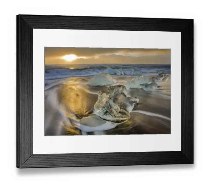 Framed Print : Diamond ice chards from calving icebergs on black sand beach at Jokulsarlon in south