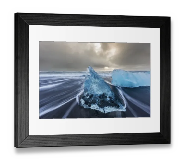Framed Print : Diamond ice chards from calving icebergs on black sand beach at Jokulsarlon in south Framed Print : Diamond ice chards from calving icebergs on black sand beach at Jokulsarlon in south