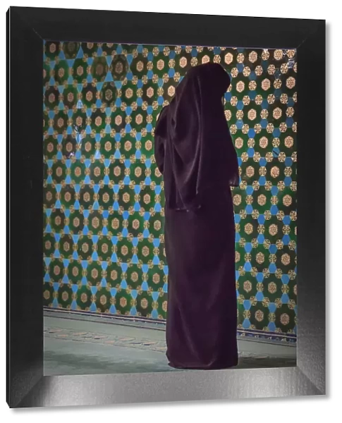 Turkey, Marmara, Bursa Province, Bursa, Green Mosque, Yesil Cami. Covered woman praying