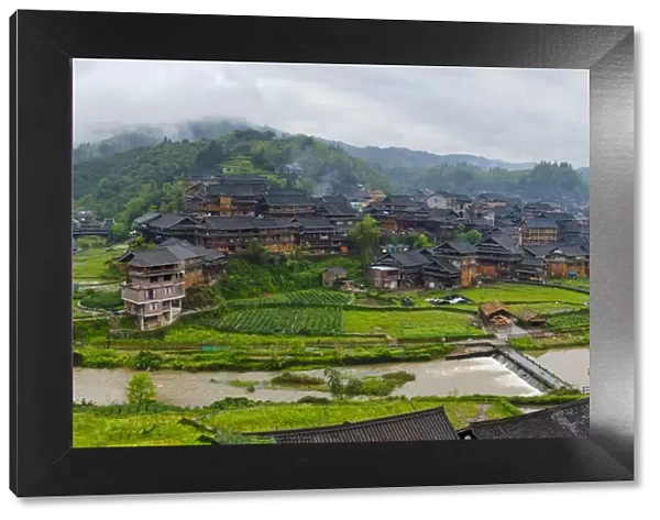 Village with farmland in morning mist, Chengyang, Sanjiang, Guangxi Province, China