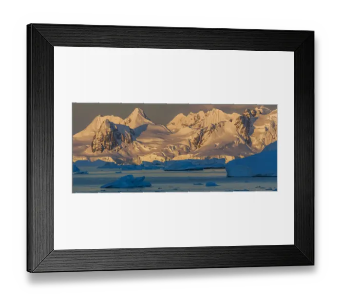 Framed Print : Morning light shines on the mountains of Antarctica, while the icebergs in the ocean Framed Print : Morning light shines on the mountains of Antarctica, while the icebergs in the ocean