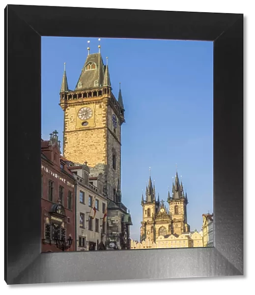 Europe, Czech Republic, Prague. Cityscape view on the clock tower and Tyn cathedral