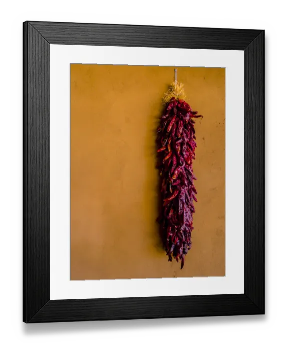 Framed Print : Santa Fe, New Mexico. The Long, Dried, Group of Red Chili Peppers and a Terra Cotta wall Framed Print : Santa Fe, New Mexico. The Long, Dried, Group of Red Chili Peppers and a Terra Cotta wall