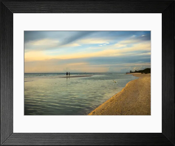 Framed Print : People standing on a sandbar in the water watching sunset