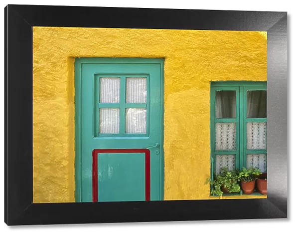 Greece, Nissyros. Door and window of colorful house