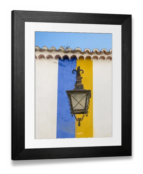 Framed Print : Europe, Portugal, Obidos. Wrought iron lantern hanging from a colorful stripped wall Framed Print : Europe, Portugal, Obidos. Wrought iron lantern hanging from a colorful stripped wall