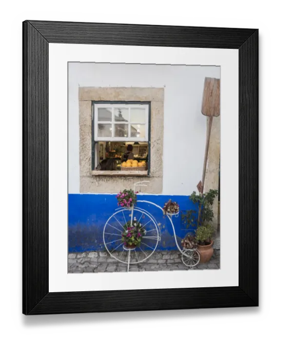 Framed Print : Portugal, Obidos. Cute bicycle planter in front of a bakery in the walled city of Obidos