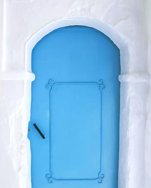 Africa, Morocco, Chefchaouen. Blue door in white building