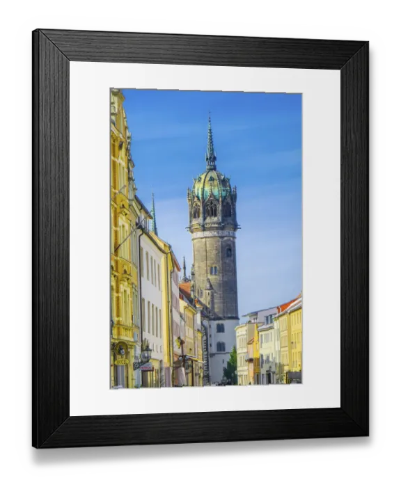 Framed Print : Snow-covered street with shops and restaurants. All Saints Church (Schlosskirche)