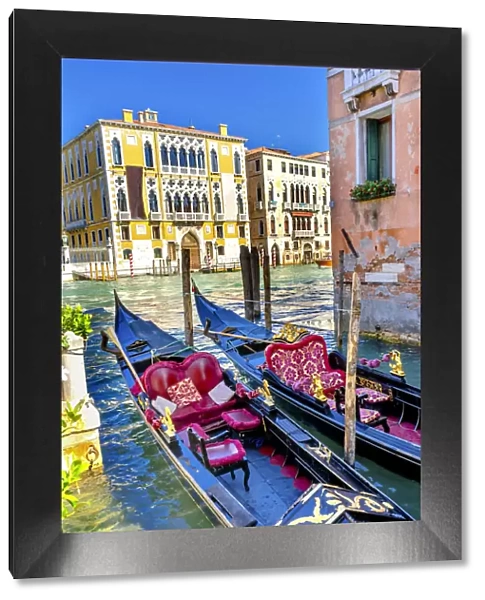 Colorful gondolas, Grand Canal buildings and boat reflection, Venice, Italy