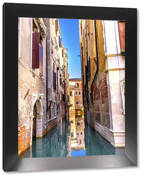 Colorful small canal building reflection, Venice, Italy