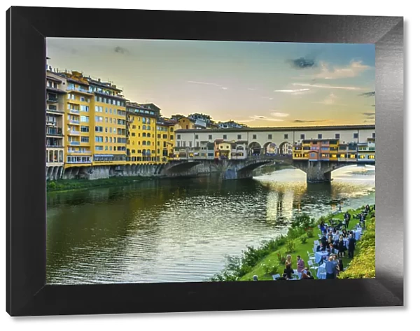 Evening dinner party by the Arno River, Ponte Vecchio, Florence, Tuscany, Italy