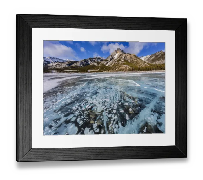 Framed Print : Mt. Abraham at sunrise and methane ice bubbles under clear ice on Abraham Lake near Nordegg