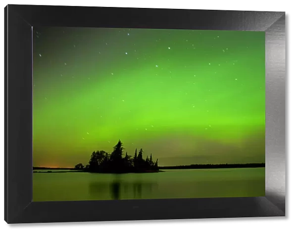 Canada, Manitoba, Whiteshell Provincial Park. Aurora borealis reflects on lake. Credit as
