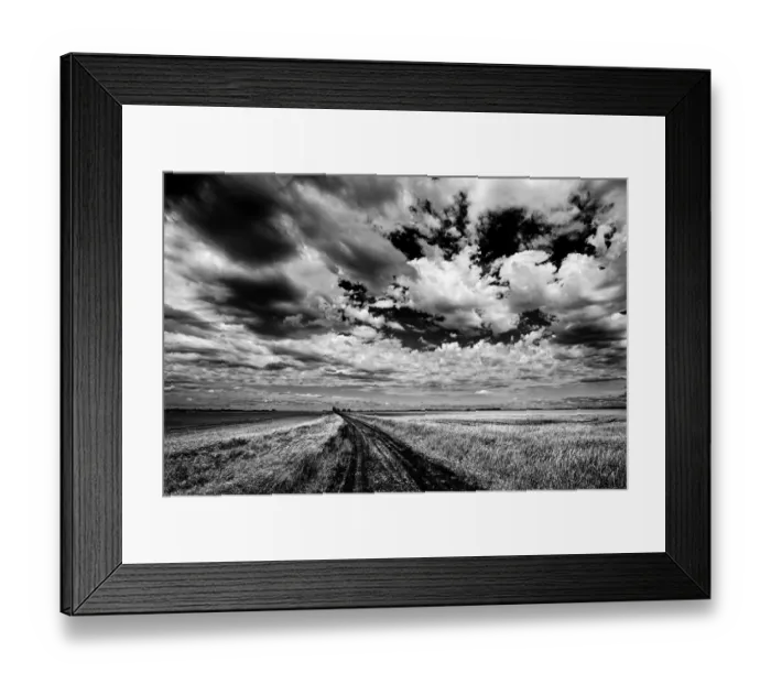 Framed Print : Canada, Manitoba, Grande Pointe. Black and white of clouds and road through field