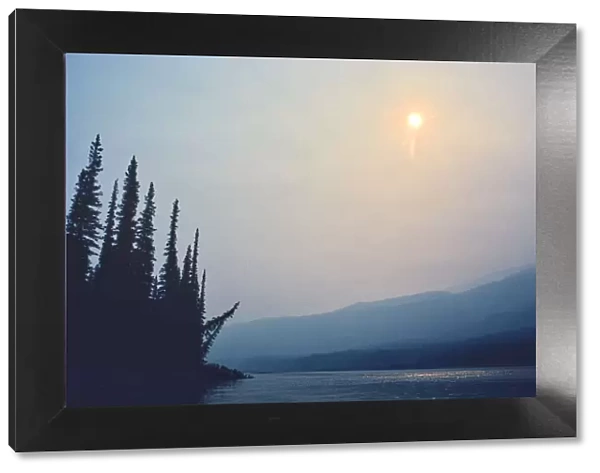Canada, Northwest Territories, Nahanni National Park. Fire smoke on Nahanni River