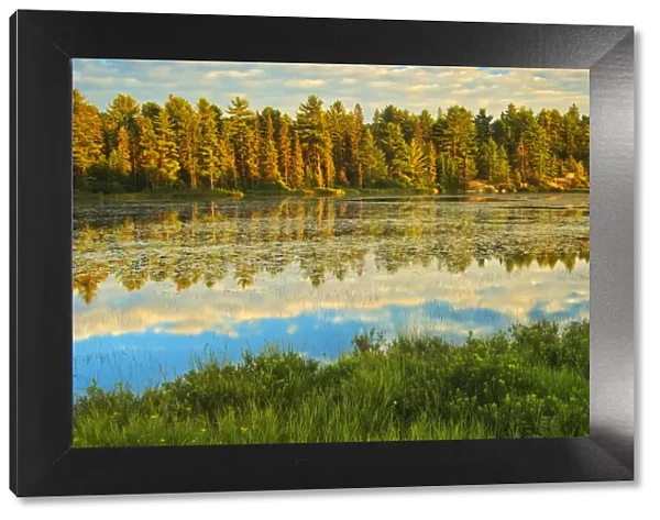 Canada, Ontario, Algonquin Provincial Park. Lake reflections at sunset. Credit as