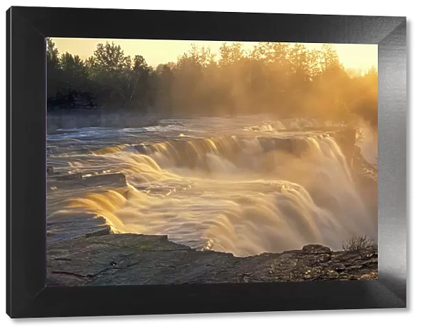 Canada, Ontario, Kakabeka. Kaministiquia River at Kakabeka Falls at sunset. Credit as