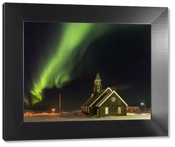 Northern Lights over the Zions Church. Ilulissat at the shore of Disko Bay, center for tourism