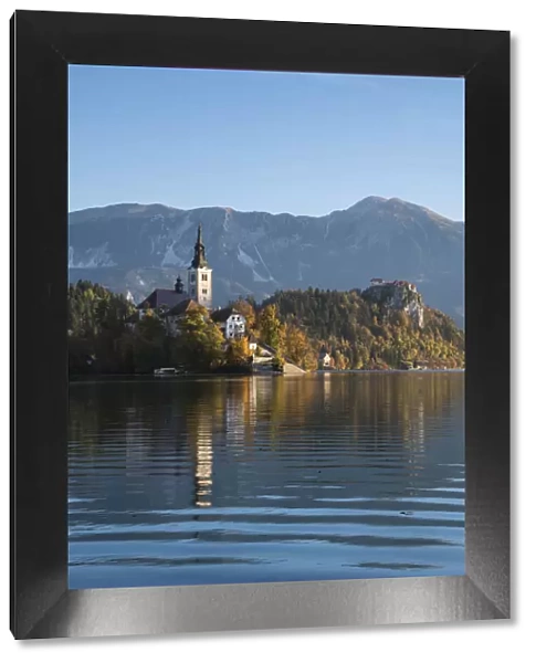 Slovenia, Bled. The Church of the Assumption of Maria is reflected in the calm waters