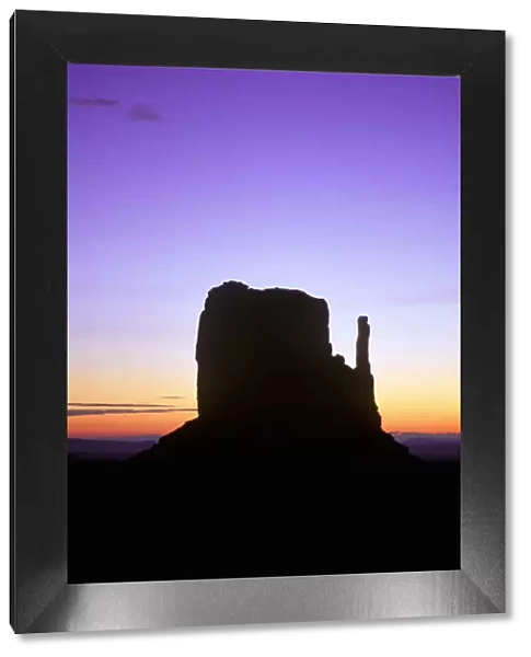 Mitten Buttes silhouetted against dawn sky, Monument Valley Navajo Tribal Park, Arizona, USA