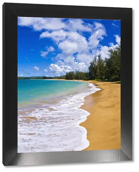 Empty beach and blue Pacific waters on Hanalei Bay, Island of Kauai, Hawaii, USA