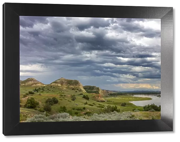 Badlands and storm clouds along the Yellowstone River near Culbertson, Montana, USA