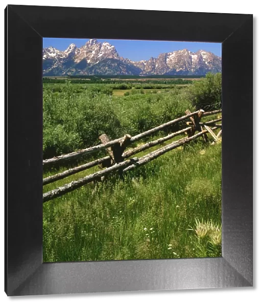 USA, Wyoming, Grand Teton National Park. Split-rail fence and mountain landscape