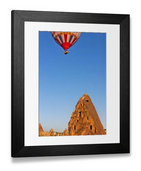 Framed Print : Hot air balloon over houses carved into rock formations, Uchisar, Cappadocia, Turkey Framed Print : Hot air balloon over houses carved into rock formations, Uchisar, Cappadocia, Turkey