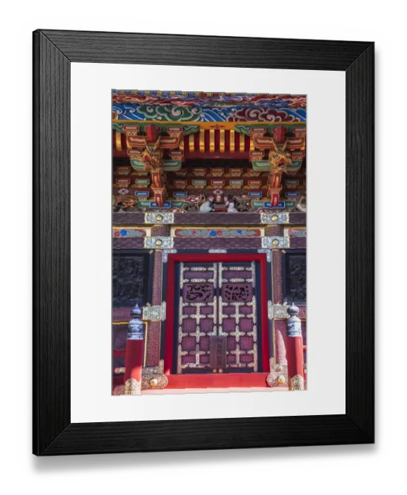 Framed Print : Close-up view of the colorful door and roof of a temple