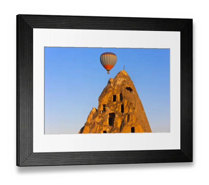 Framed Print : Hot air balloon over houses carved into rock formations, Uchisar, Cappadocia, Turkey Framed Print : Hot air balloon over houses carved into rock formations, Uchisar, Cappadocia, Turkey