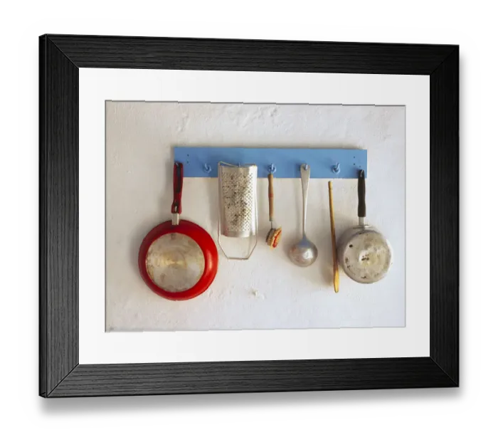 Framed Print : Greece, Corfu. Kitchen utensils hang on rack