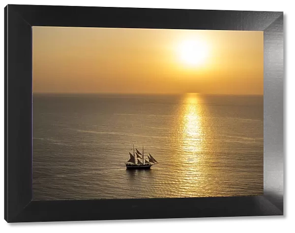 Europe, Greece, Santorini, Cyclades. Sailboat on ocean at sunset