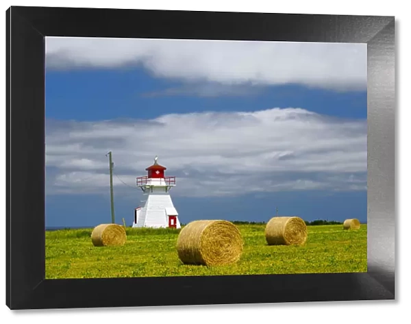 Canada, Prince Edward Island, Darnley. Lighthouse and farm bales