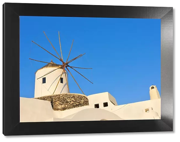 Windmill on the coast of Aegean Sea. Oia, Santorini Island, Greece
