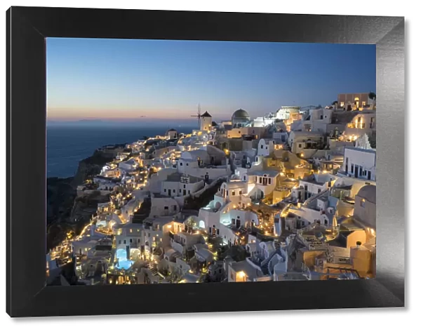 Greece, Santorini. The village of Oia glowing in the post-sunset light as the town s