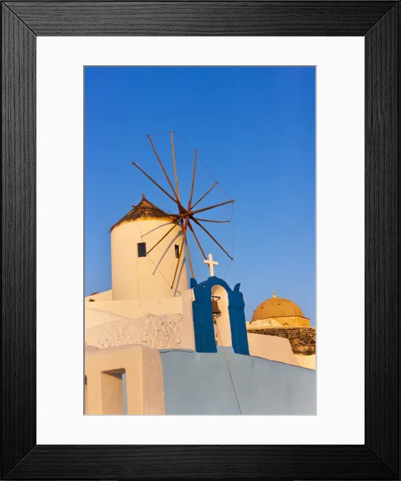 Framed Print : Church bell tower and windmill on the coast of Aegean Sea. Oia, Santorini Island, Greece Framed Print : Church bell tower and windmill on the coast of Aegean Sea. Oia, Santorini Island, Greece