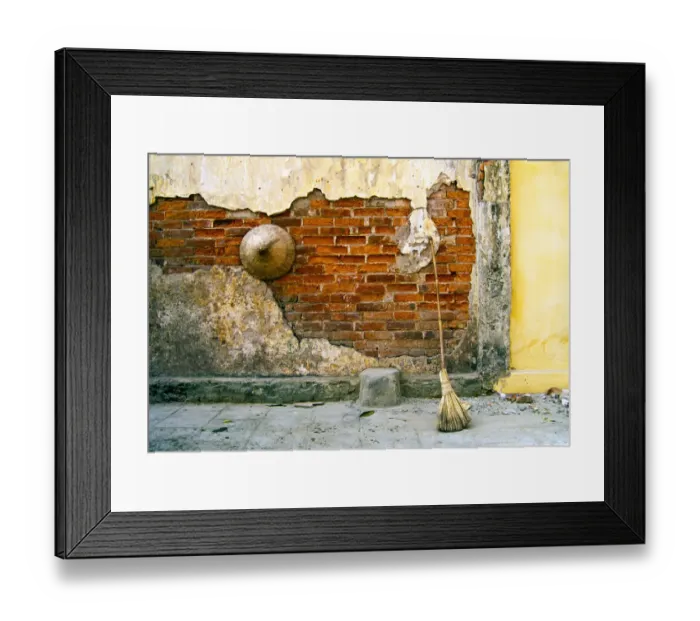 Framed Print : Still-life of a hat and broom against a weathered wall in Vietnam Framed Print : Still-life of a hat and broom against a weathered wall in Vietnam