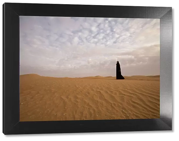 Bedouin woman in the desert. Abu Dhabi, United Arab Emirates