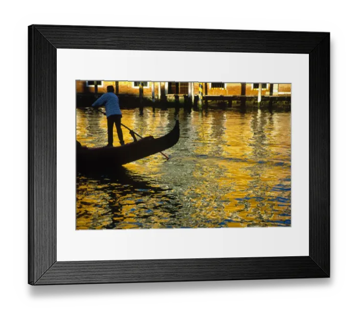 Framed Print : Italy, Venice. Gondolier steering gondola at sunset