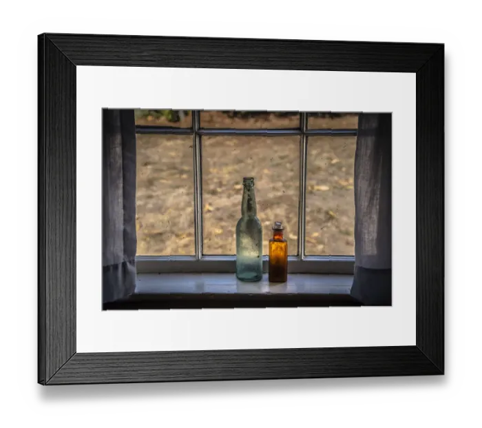 Framed Print : Two vintage bottles on window sill