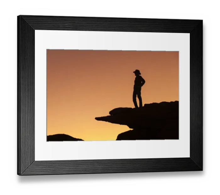 Framed Print : Man standing on rock surveying the view. (MR) Framed Print : Man standing on rock surveying the view. (MR)