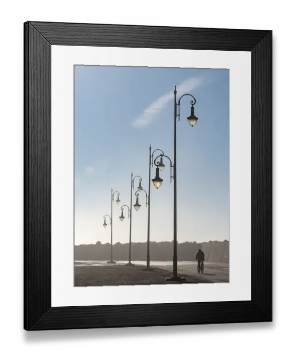 Framed Print : Africa, Morocco, Asilah. Man rides bike past lampposts Framed Print : Africa, Morocco, Asilah. Man rides bike past lampposts
