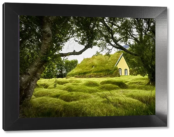Iceland, turf-roofed Hof Church and surrounding grave mounds